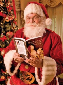 Cliff Snider, the Praying Santa, reading by a Christmas tree.
